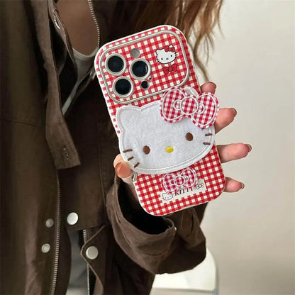 Hello Kitty Red Checkered iPhone Cover with 3D Bow displayed on a hand, showcasing its cute design and plush bow.